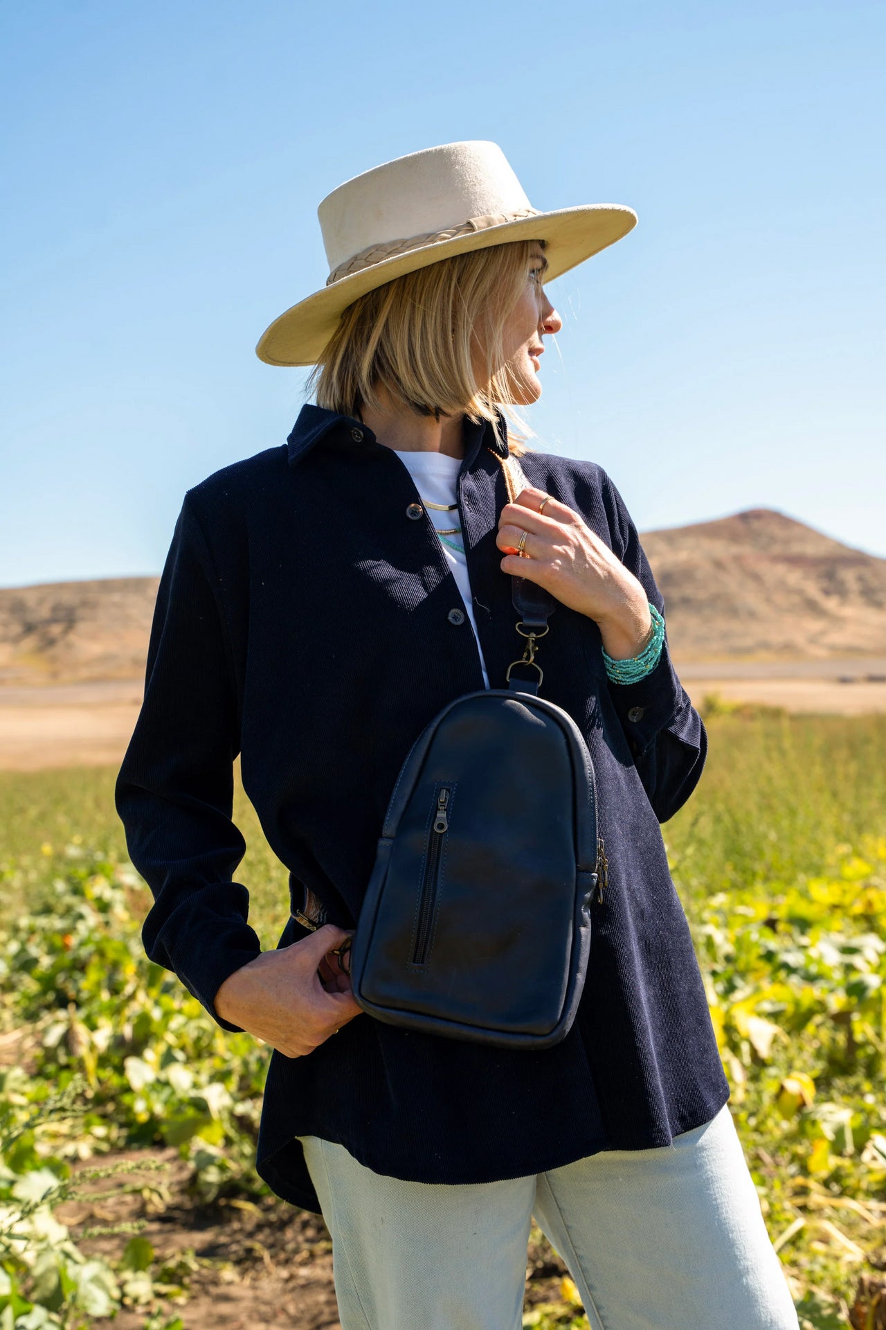 Girl in field with crossbody