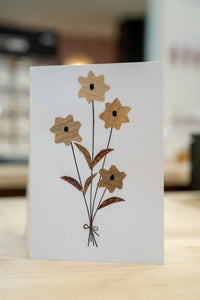 Thumbnail for Card with wooden flower design on a blurred background